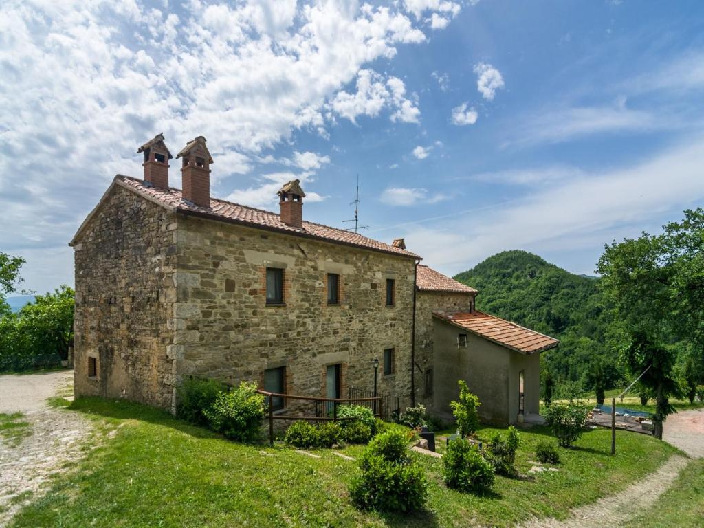 an old stone building with two chimneys on top at Beautiful Apartment in Sestino with Garden in Sestino