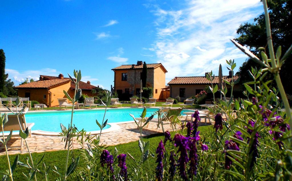 a house and a swimming pool in a yard at Apartments Borgo Toscano in Gambassi Terme