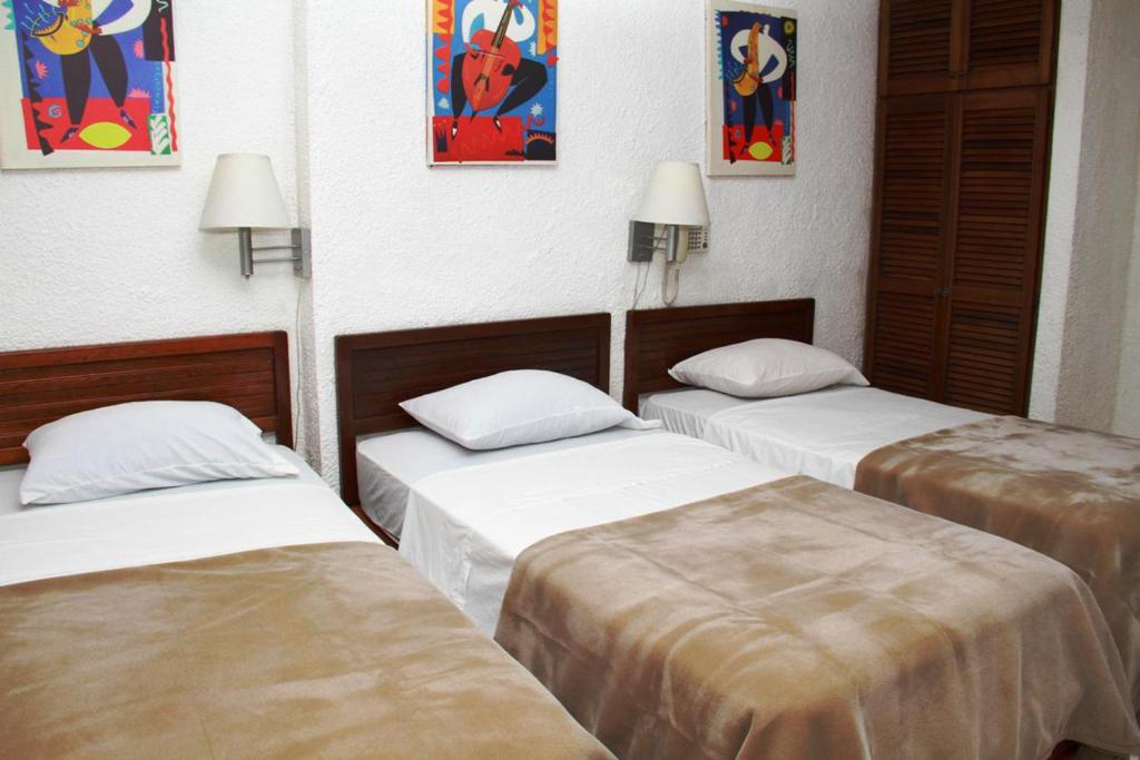 Postel nebo postele na pokoji v ubytování Hotel California Panama