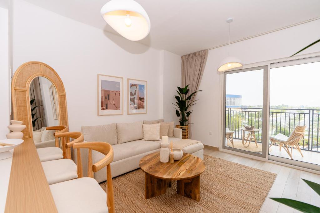 a living room with a couch and a table at One Bedroom Apartment by Otolo Homes with Free Yas Theme Park Tickets in Abu Dhabi