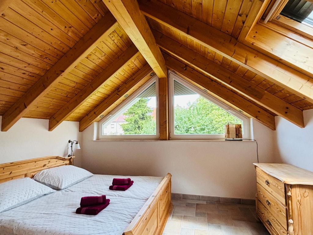 a bedroom with a bed and a large window at Casa Armonia Halle- Ruhige Ferienwohnung am Pestalozzipark und Gesundbrunnen in Halle an der Saale