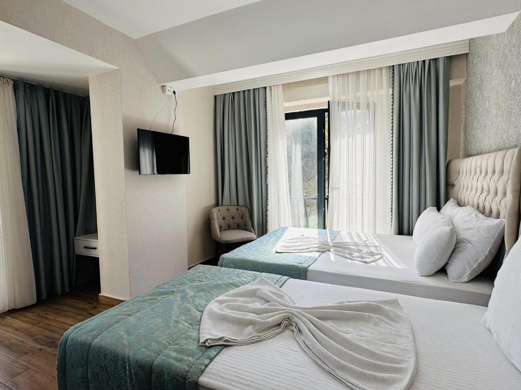 Postel nebo postele na pokoji v ubytování Saklıkoy Resort Otel