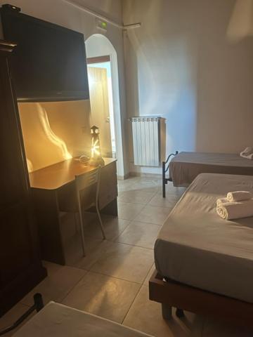 Ένα ή περισσότερα κρεβάτια σε δωμάτιο στο B&B Viale Roma - roomexperience