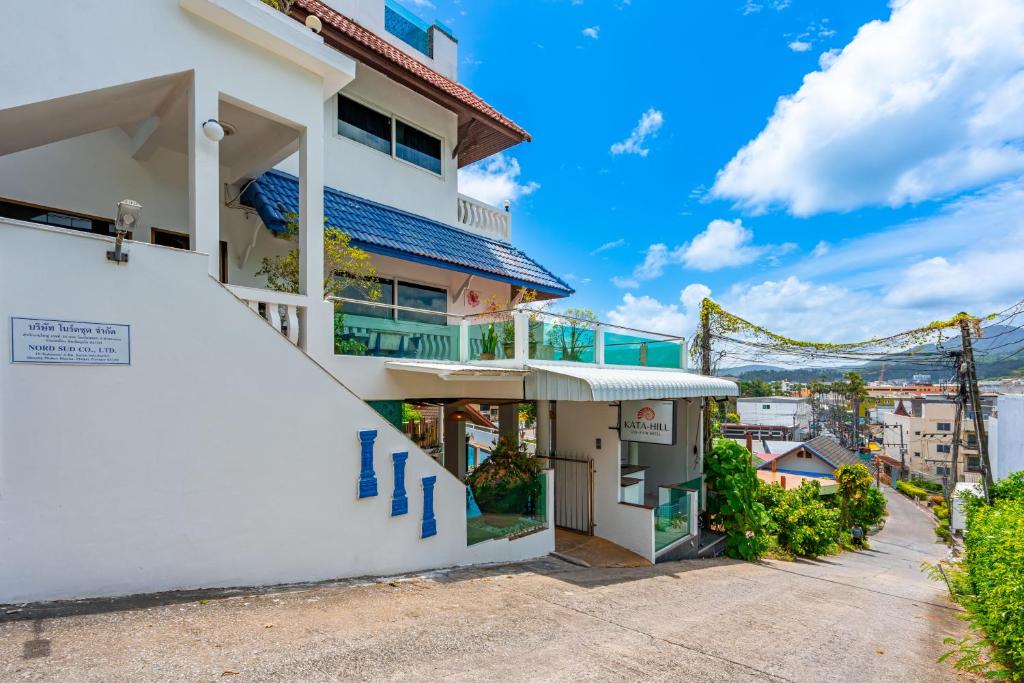 a white apartment building with a balcony at Hotel Kata Hill Sea View in Kata Beach