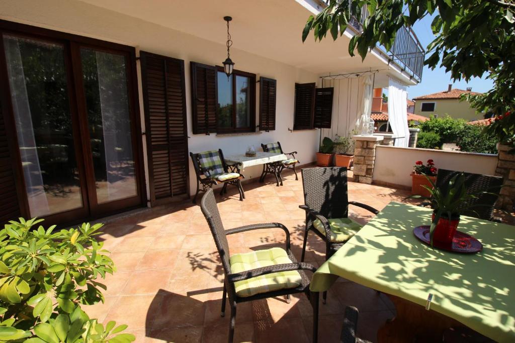 a patio with a table and chairs on a patio at Lisa 2 near the beach in Novigrad Istria