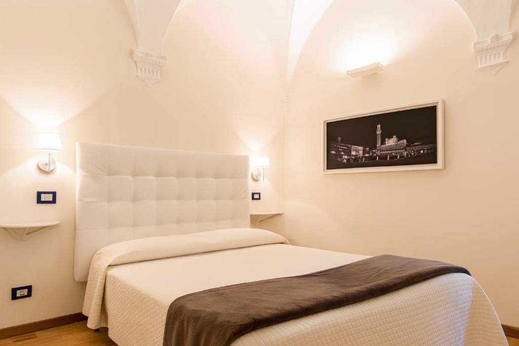 Postel nebo postele na pokoji v ubytování B&B Quattro Cantoni