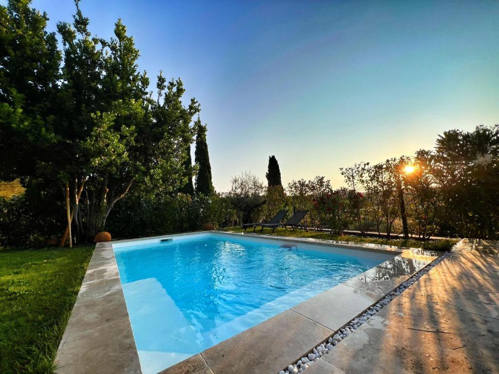 a swimming pool in the backyard of a house at Le Moulin in Aix-en-Provence