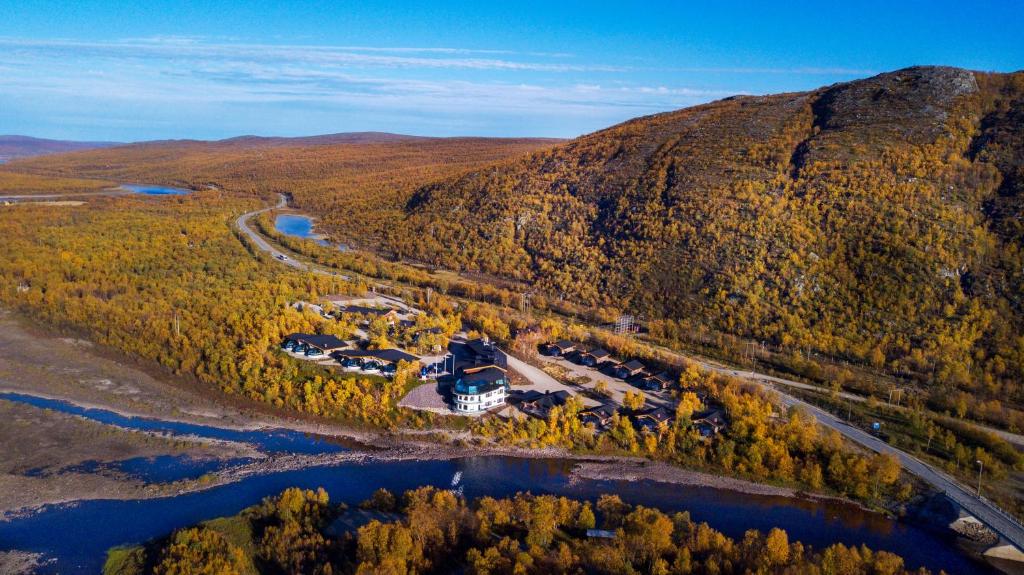 an aerial view of a house on a hill next to a river at Utsjoki Arctic Resort in Utsjoki