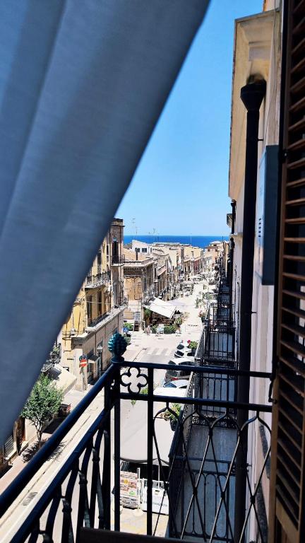 a view of a city from a balcony at Disìu Apartment con Jacuzzi in centro a Castellammare del Golfo in Scopello