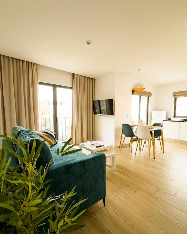 a living room with a couch and a dining room at BIA D'Olaf Apartments in Santa Maria