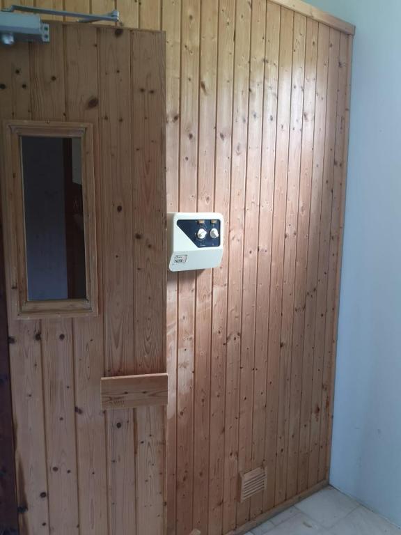 a wood paneled wall with a security camera on it at La Gaulette Seaview Villa in La Gaulette