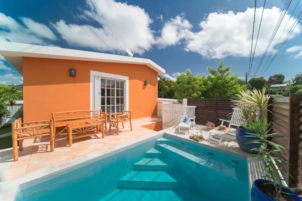 a villa with a swimming pool and a house at Coconut Bay House avec Piscine et Jacuzzi in Le Robert