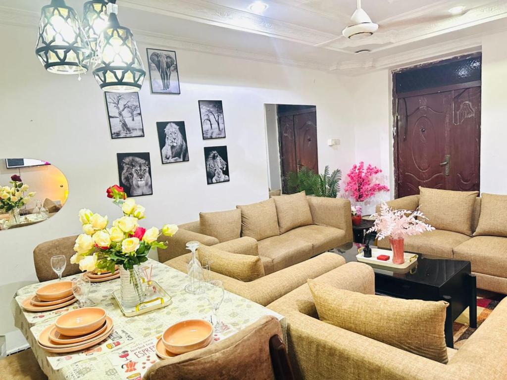a living room with couches and a table at Big Master bed with Private bath, Beautiful view, fast WIFI at City Centre in Dar es Salaam