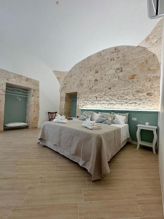 a bedroom with a large bed in a brick wall at ALLE TERRAZZE di Castellana Grotte in Castellana Grotte