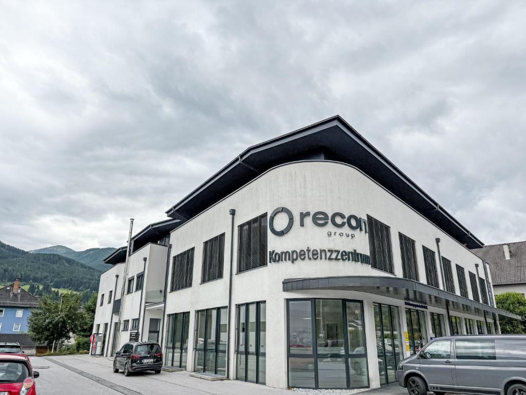 a building with a car parked in front of it at Apartment Mentenwirt Alp Lungau by Interhome in Sankt Michael im Lungau