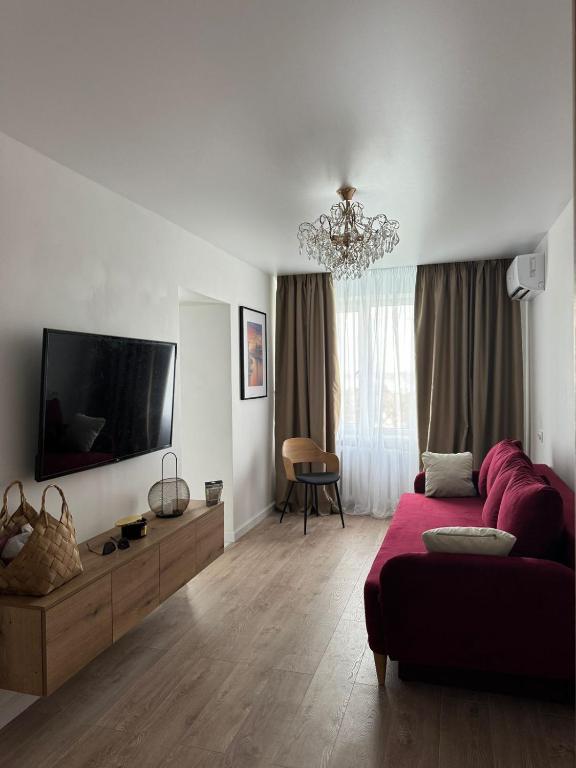 a living room with a couch and a flat screen tv at Chornomorsk Apartment in Chornomorsk
