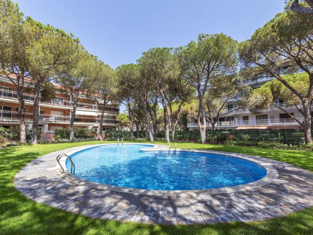 an empty swimming pool in a park with trees at Apartment Mar d'Aro by Interhome in Platja  d'Aro