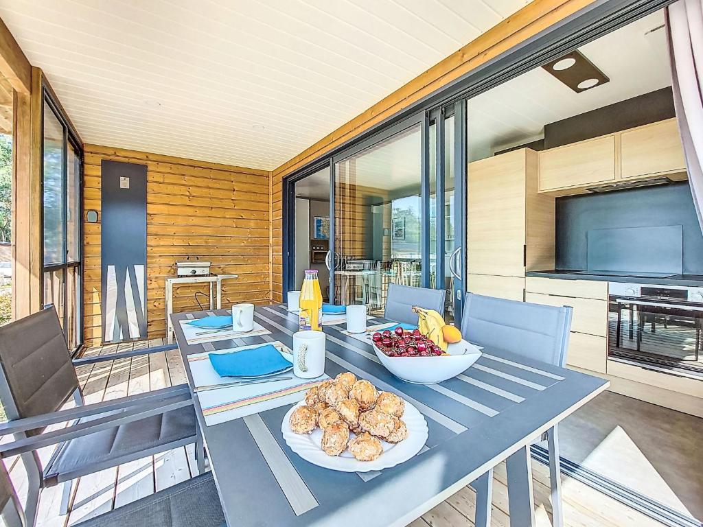 a table with two plates of food on it at Holiday Home Chalet moderne La Baule-Guérande by Interhome in Guérande