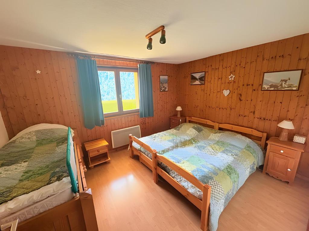 Postel nebo postele na pokoji v ubytování Chalet Loupnots 2P avec vue