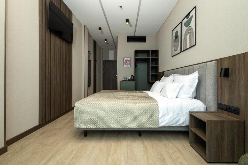a bedroom with a large bed and a television at Hotel Centrum Business in Krakow