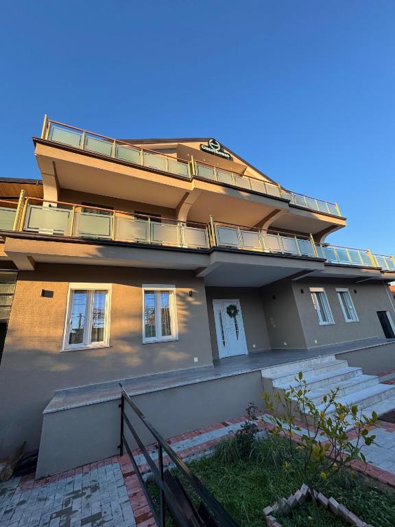a building with a balcony on top of it at Blessed guest house in Shkodër