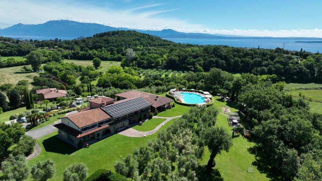 an aerial view of a house with a swimming pool at Garda Hill Boutique Apartments with Panoramic Pools e Agriturismo in Soiano del Lago