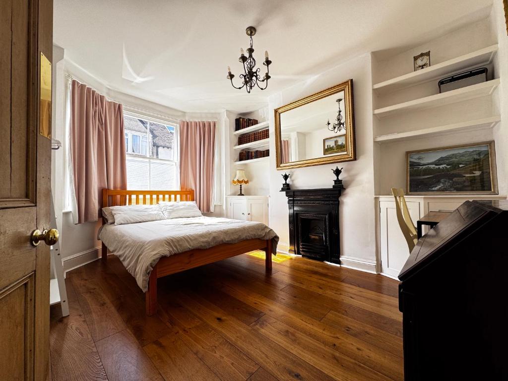 a bedroom with a bed and a fireplace at The OX1 in Oxford