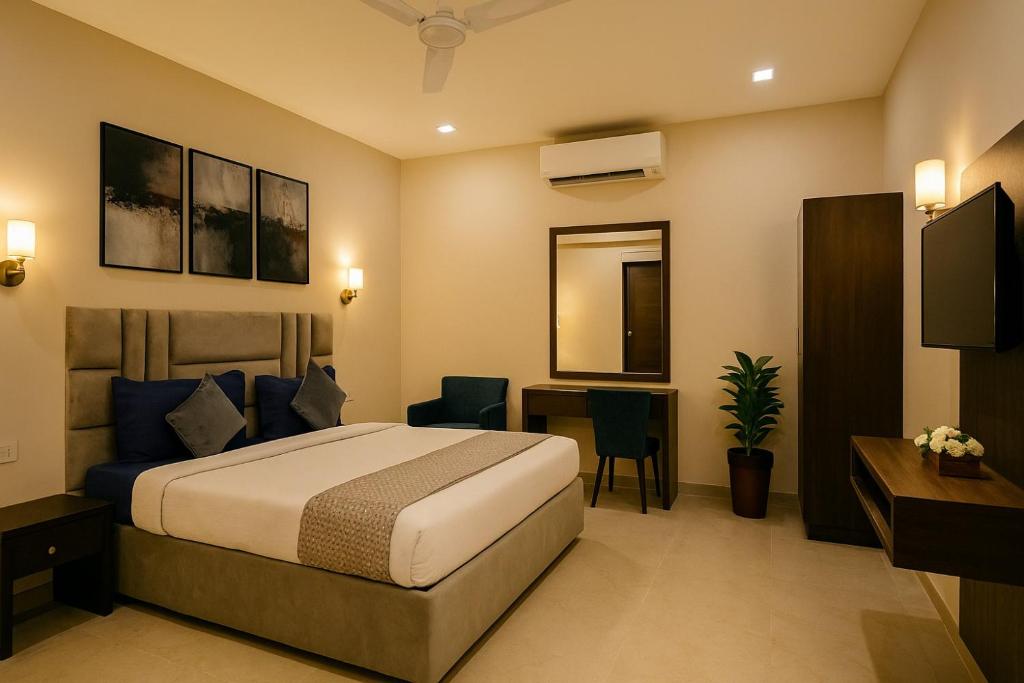 a hotel room with a bed and a desk at Golden Temple Paradise Stays in Amritsar
