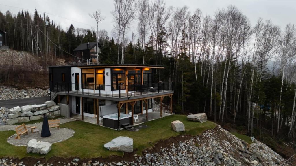 a house on top of a hill with trees at Ski Chalet with Sauna - Mountain - L'Elegant in Saint Come