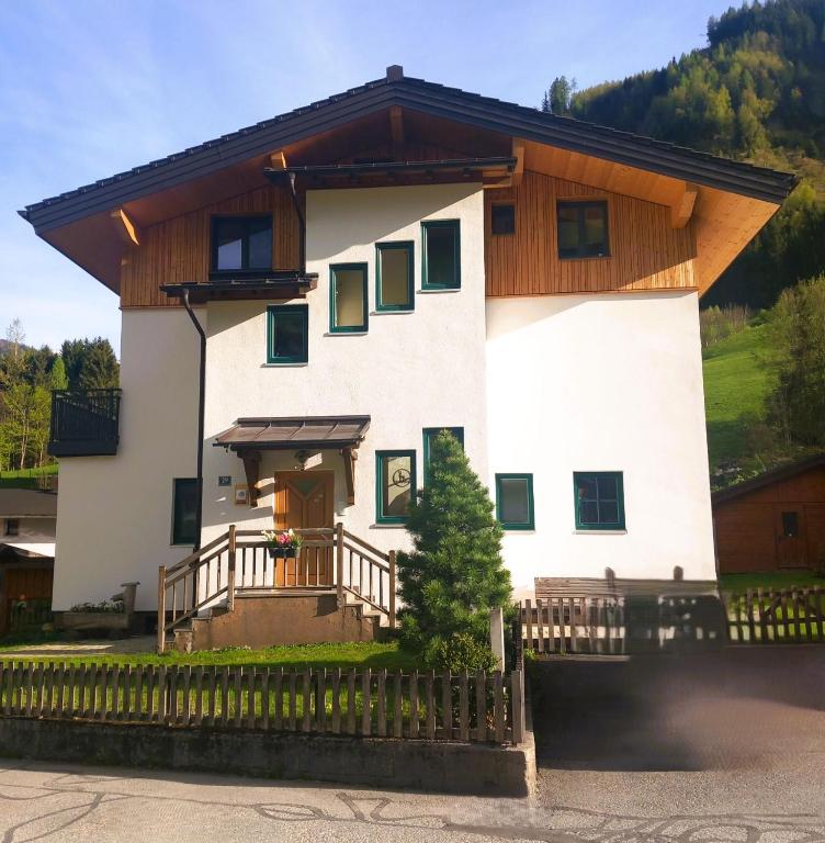 a large white house with a wooden roof at Haus Gipfelblick in Rauris