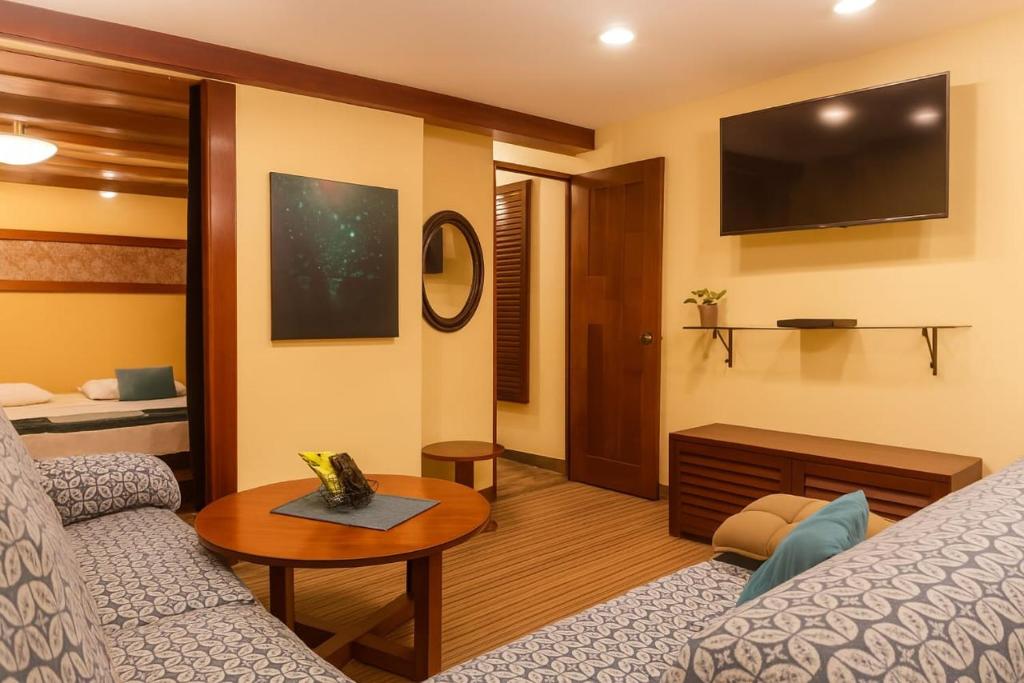 a living room with a couch and a tv at Amazon Home-Feliz Puerta in Iquitos