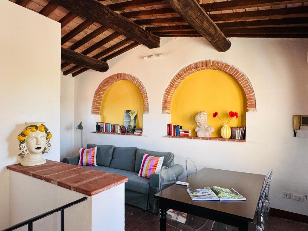 a living room with a couch and a table at Santa Maria Dreaming Rooftop in Pisa