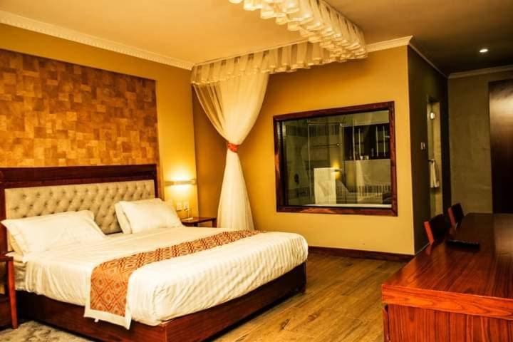a bedroom with a large bed and a window at Siritamu Resort & Spa in Bungoma