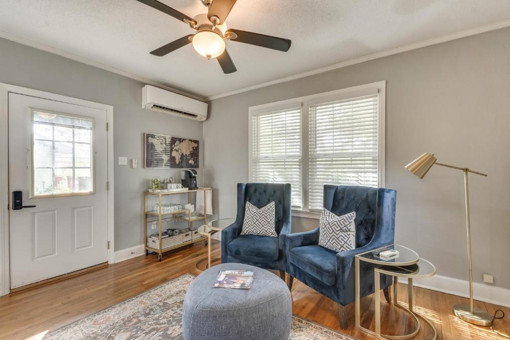 a living room with two chairs and a ceiling fan at 3 Blocks to Pensacola Bay Charming Apartment! in Pensacola