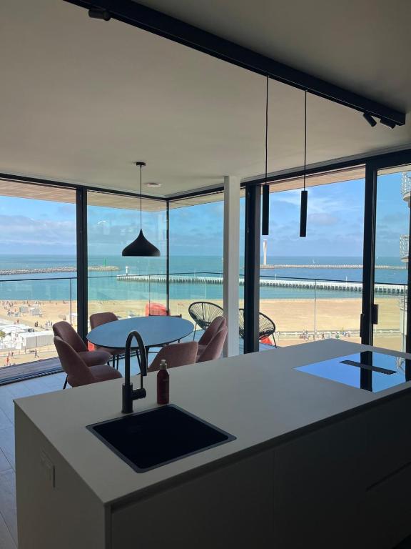 a kitchen with a view of the beach from a house at El Mirador - Quality Stay in Ostend