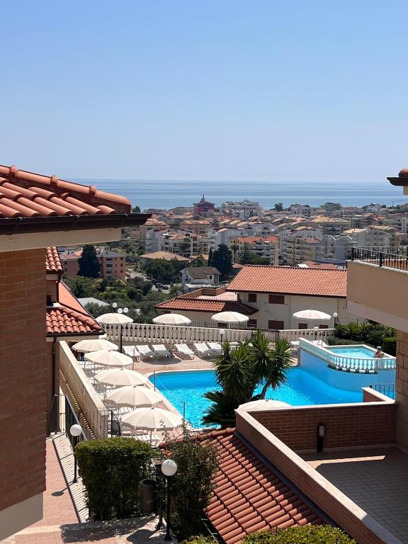 a view of a resort with two pools and umbrellas at Heleni Apartment in Tortoreto Lido