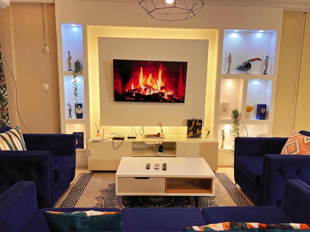a living room with a fire in the fireplace at Casa de Luna home in Douala