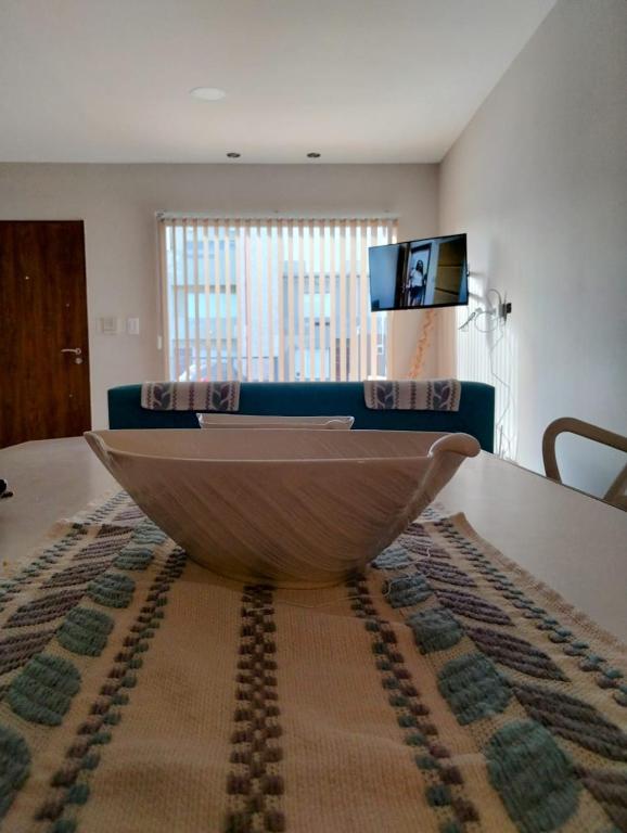 a wooden boat sitting on a table in a living room at Descanso en el Sur in Playa Unión