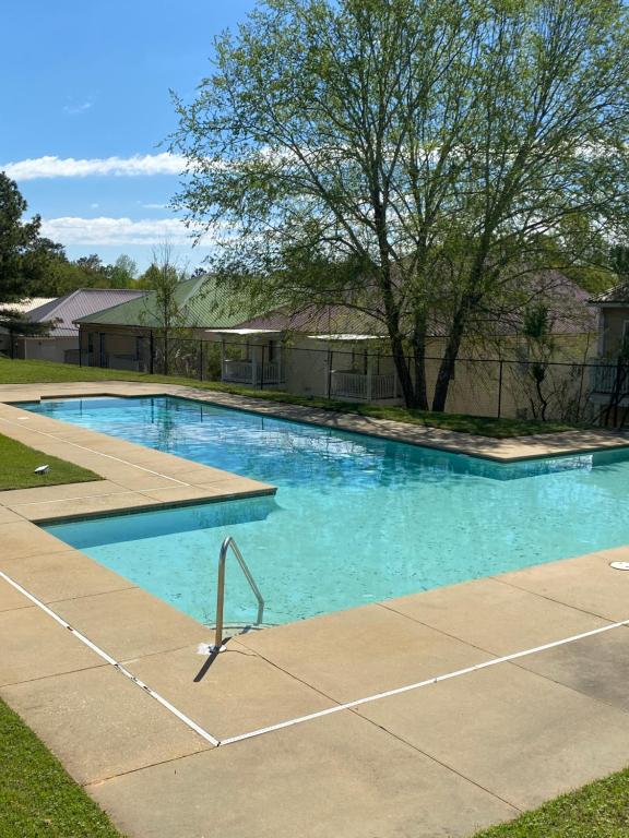 a swimming pool with blue water in a yard at Private Getaway with Balcony in Columbus