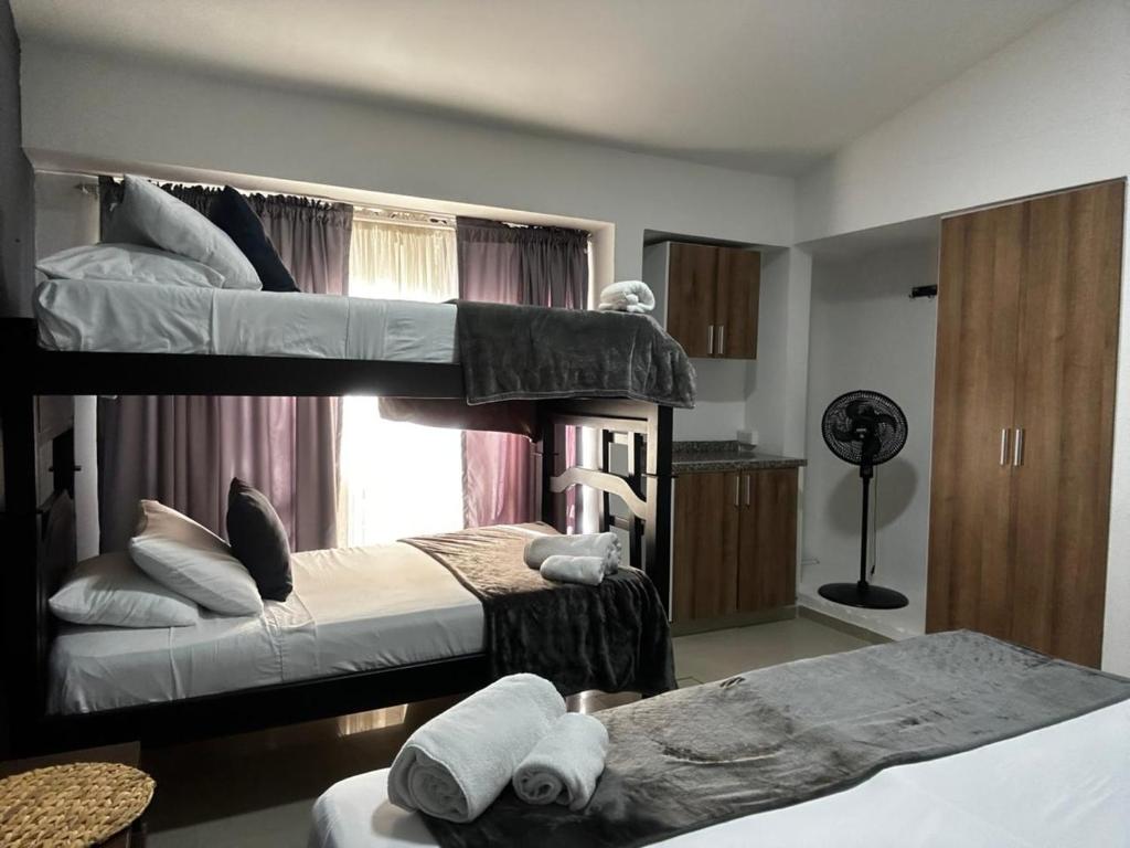a room with two bunk beds and a window at Hotel Torre Ejecutiva Pereira in Pereira