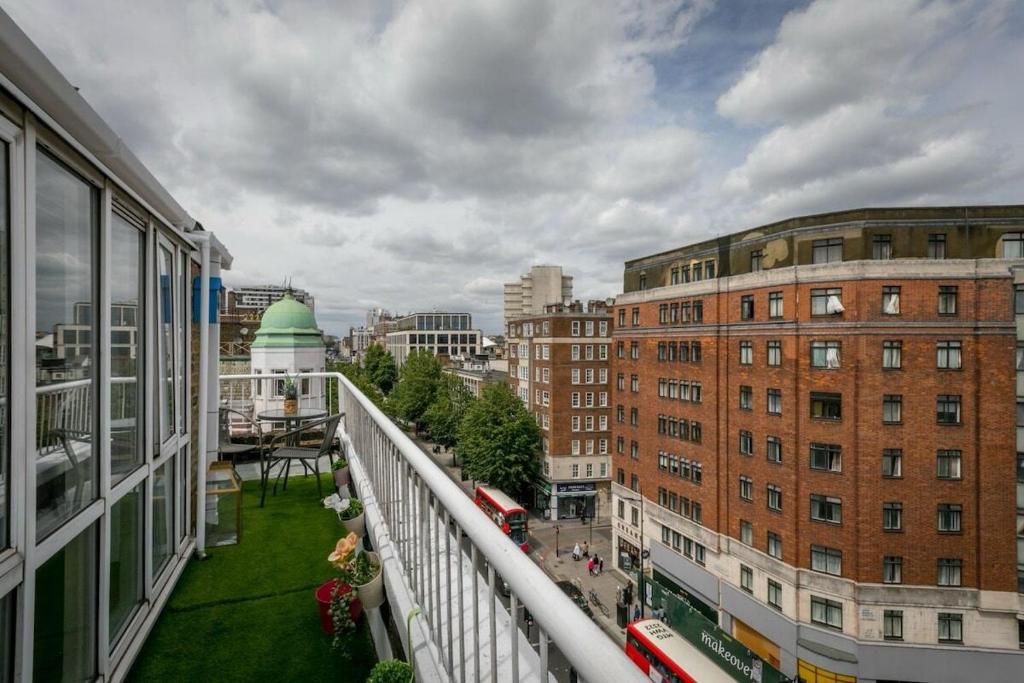 a view of a city from a balcony at Lovely & Cosy 2BR 2Bath 'Penthouse' Steps to Hyde P in London
