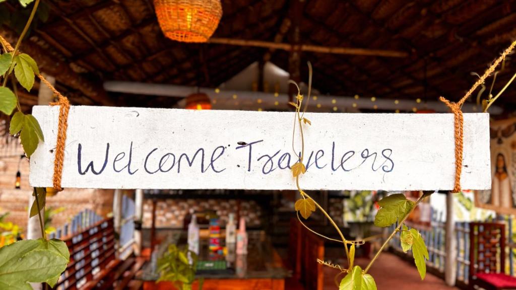 a white sign that reads welcome to the store at Hideaway in Varkala
