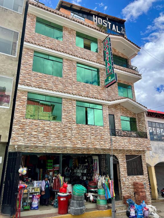 a brick building with a lost mall sign on it at Hostal Pukayaku San Luis in San Luis