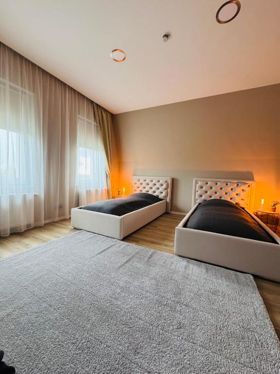two beds sitting in a room with a rug at Whitewill by Gerda in Groß Bartensleben