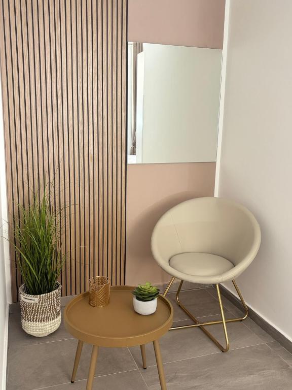 a chair and a table in a room at A due passi in Balestrate
