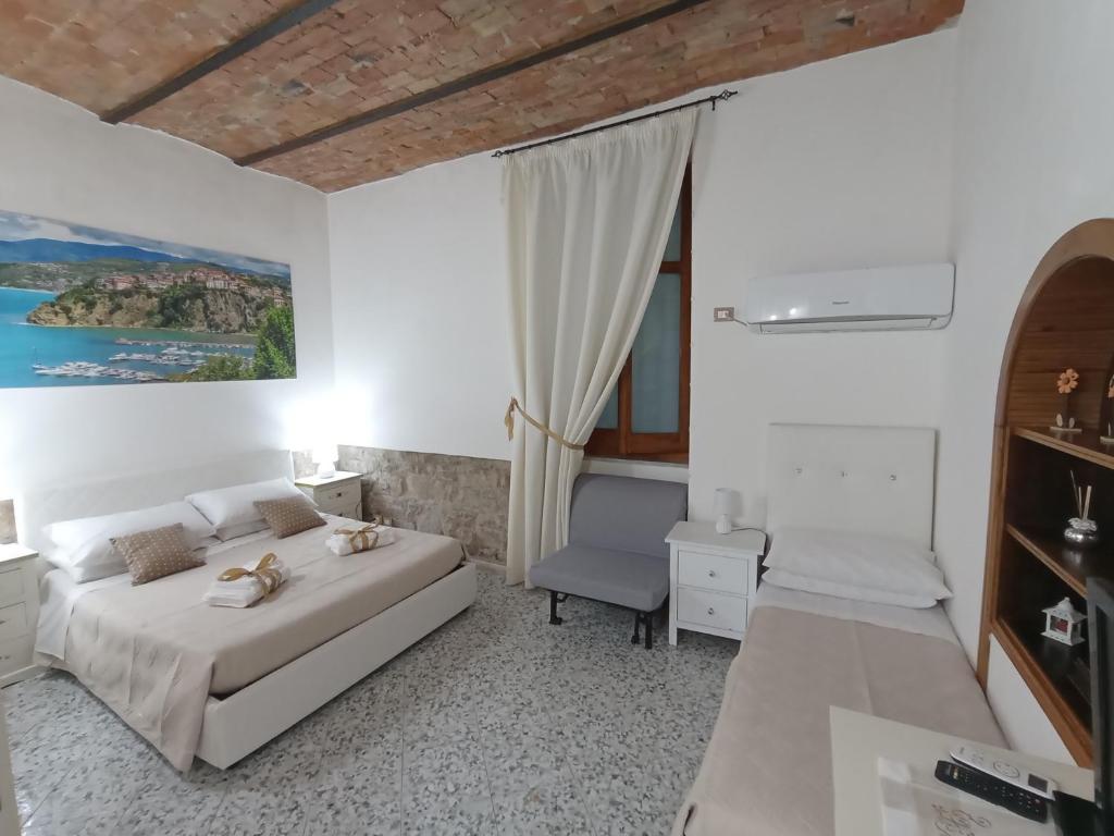 a bedroom with a bed and a desk and a chair at Le Antiche Volte suite in Agropoli