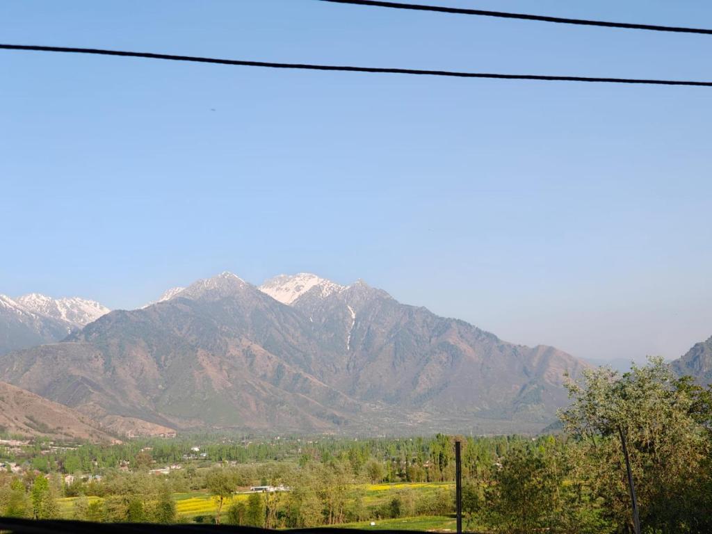 a view of a mountain range with snow at Raheemia Home Stay in Srinagar