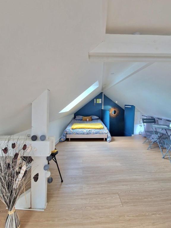 a bedroom with a bed in a attic at Le Petit Langlet - Cathedral - hyper-center in Reims