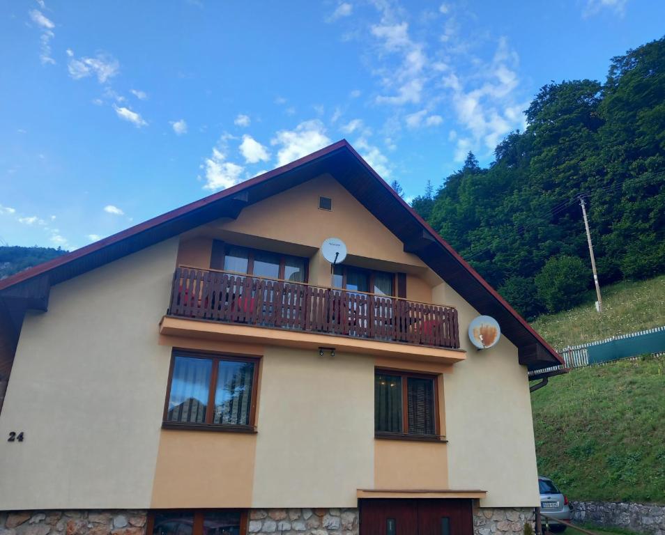 a house with a balcony on top of it at Apartmán Ivona in Dedinky