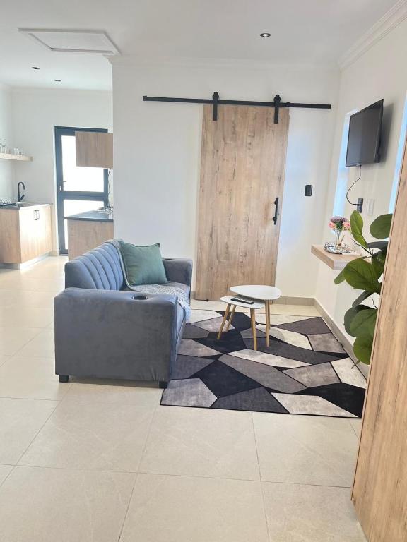 a living room with a couch and a table at Deluxe Dwellings 3 in East London